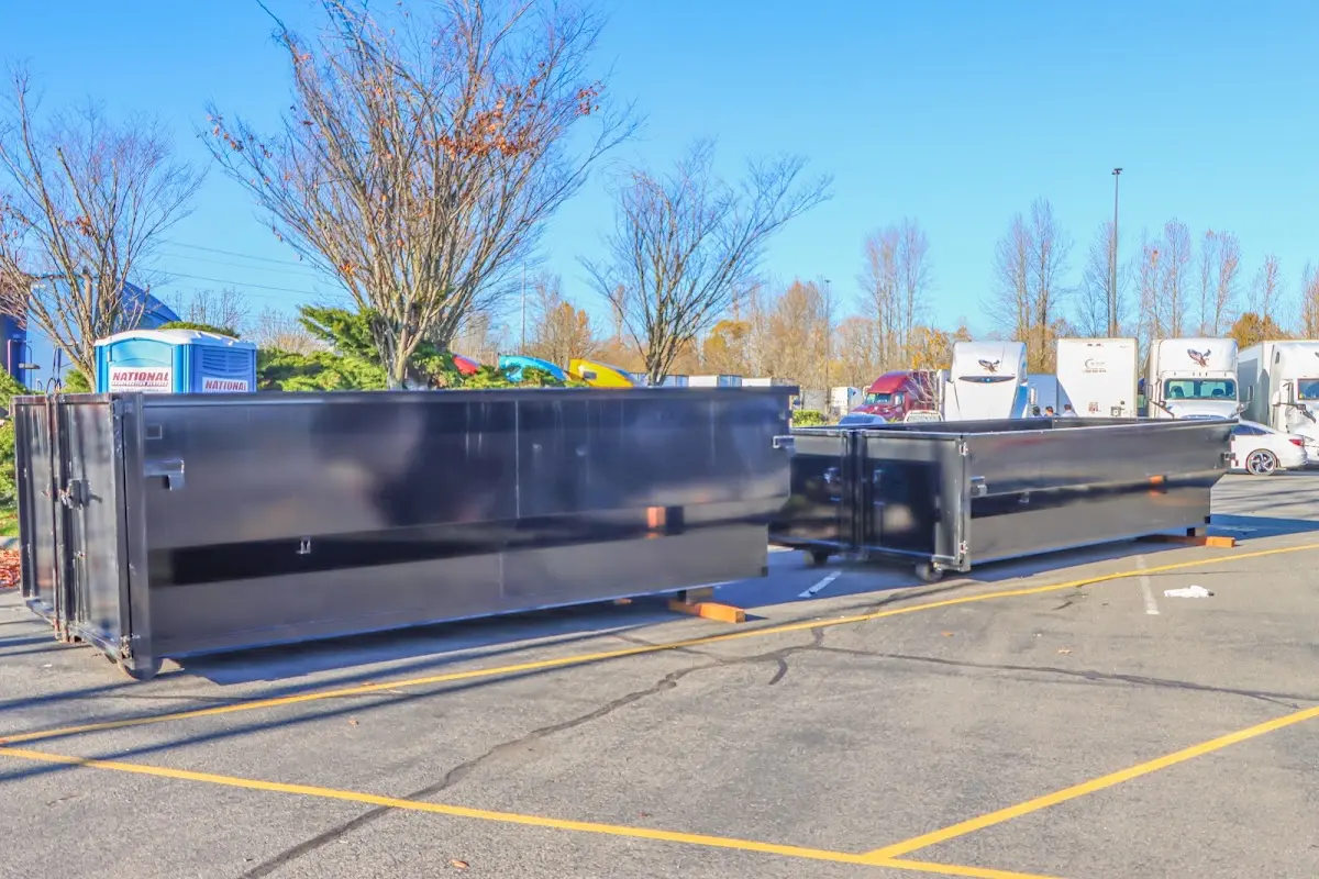 Professional dumpster rental service with roll-off container on residential driveway in Topeka